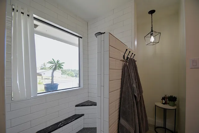 a bedroom with a bed and a flat tv screen on the dresser