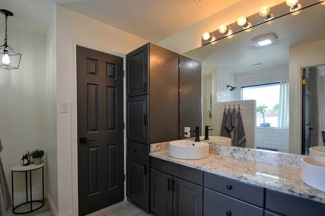 a bedroom with a large bed and a chandelier