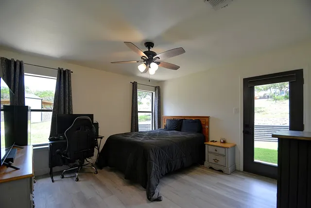 a bathroom with a granite countertop sink a toilet and a shower
