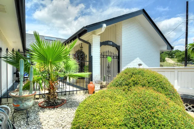 a view of roof deck with couches chairs and potted plants