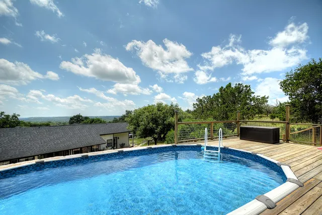 a view of a house with backyard and sitting area