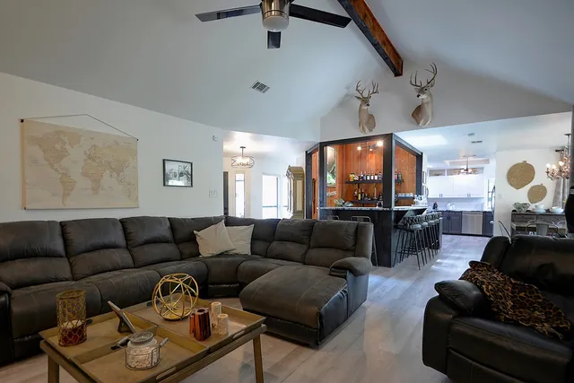 a bathroom with a granite countertop sink a large mirror and a shower