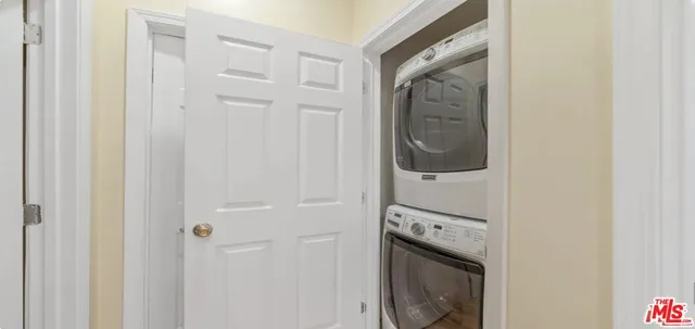 a view of a hallway with washer and dryer