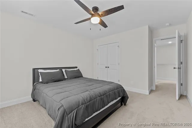 a bedroom with a bed and a ceiling fan