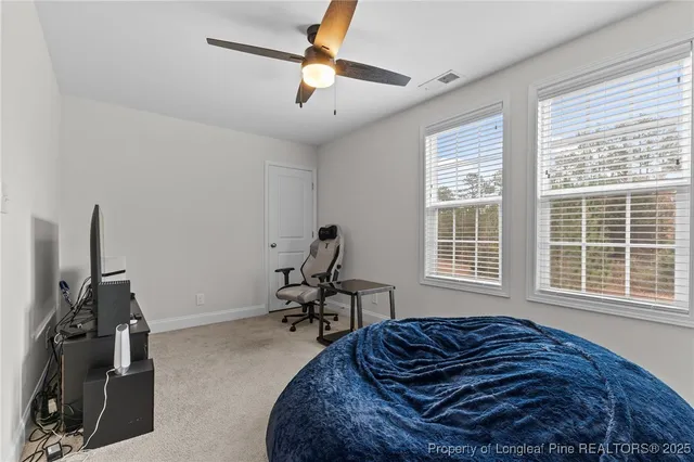 a bed sitting in a room next to a window