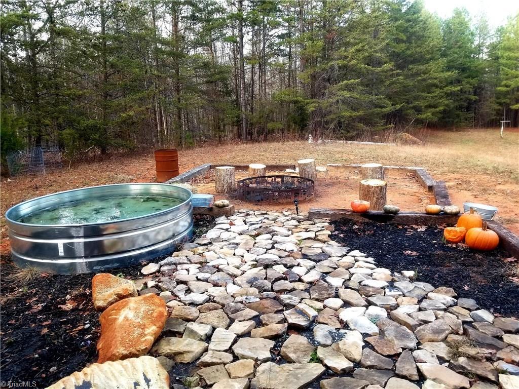 2750 Horseshoe Neck Road Lexington, NC 27295 - Photo 14 of 19 Fire pit area with livestock water basin that is used as a small pool currently ( owner was going to make it into a country style hot tub )