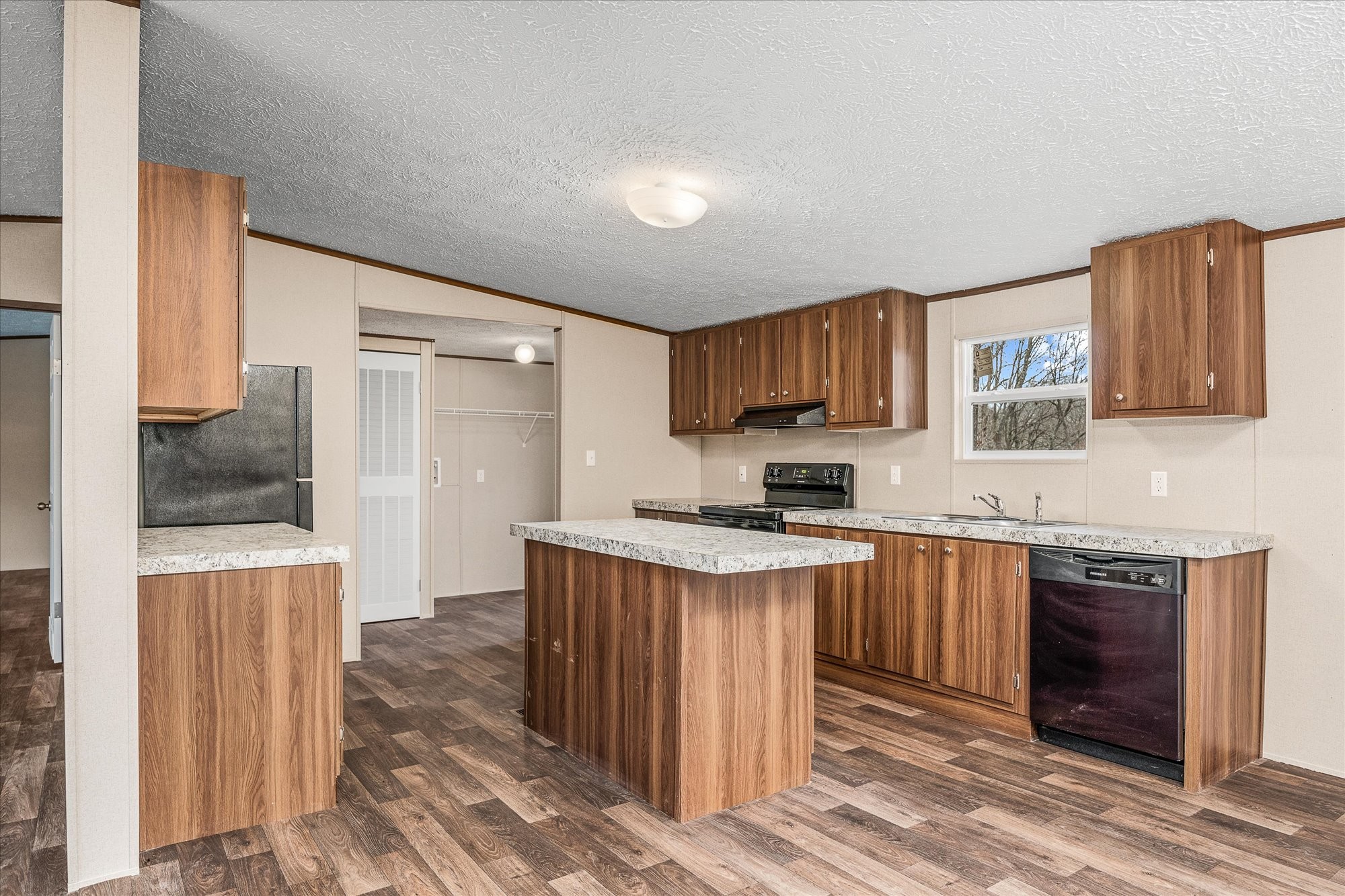 750 Maple Branch Road Sparta, TN 38583 - Photo 12 of 36 a kitchen with stainless steel appliances granite countertop a stove top oven a sink dishwasher and a refrigerator