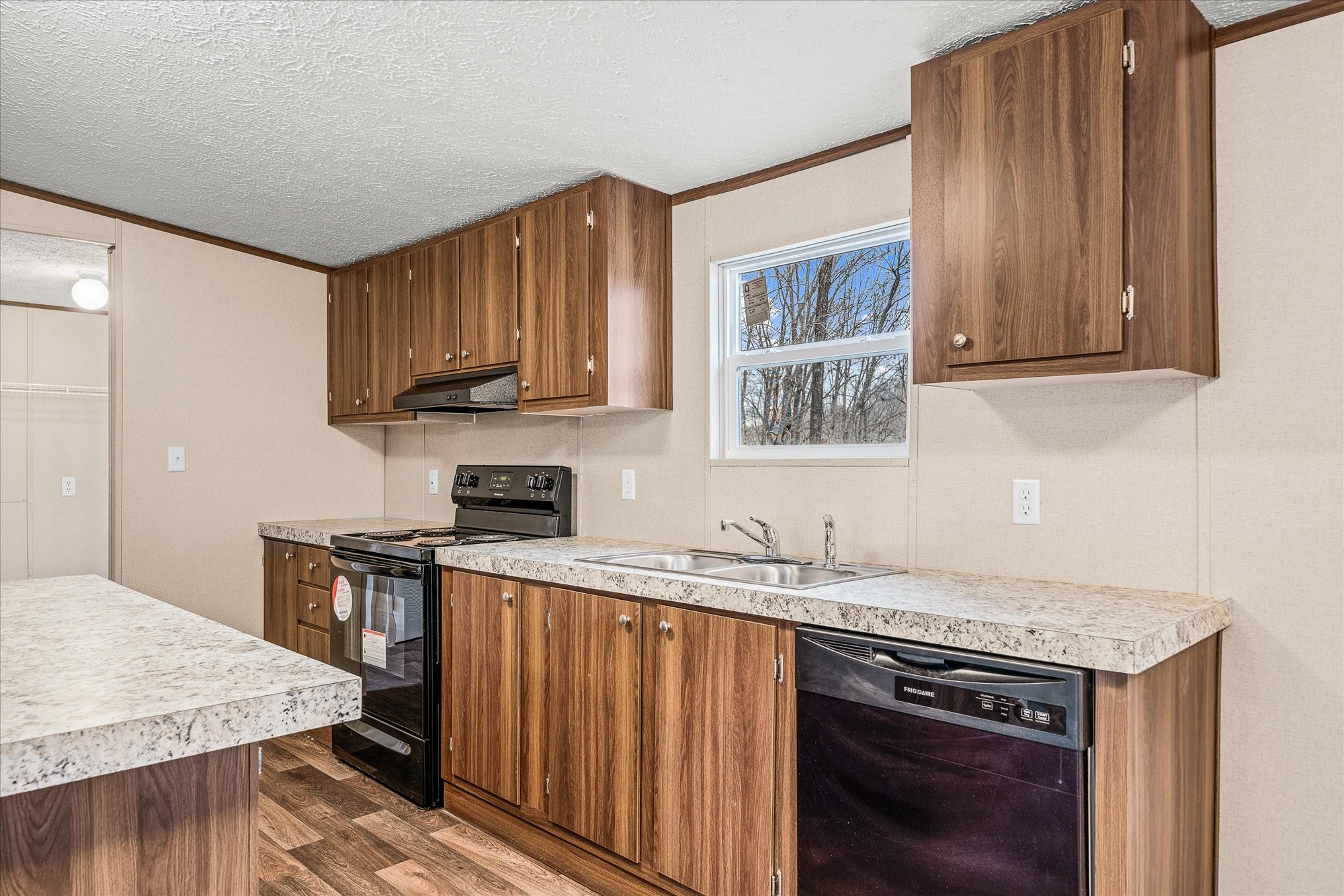 750 Maple Branch Road Sparta, TN 38583 - Photo 13 of 36 a kitchen with stainless steel appliances granite countertop a stove a sink dishwasher and a microwave with wooden cabinets