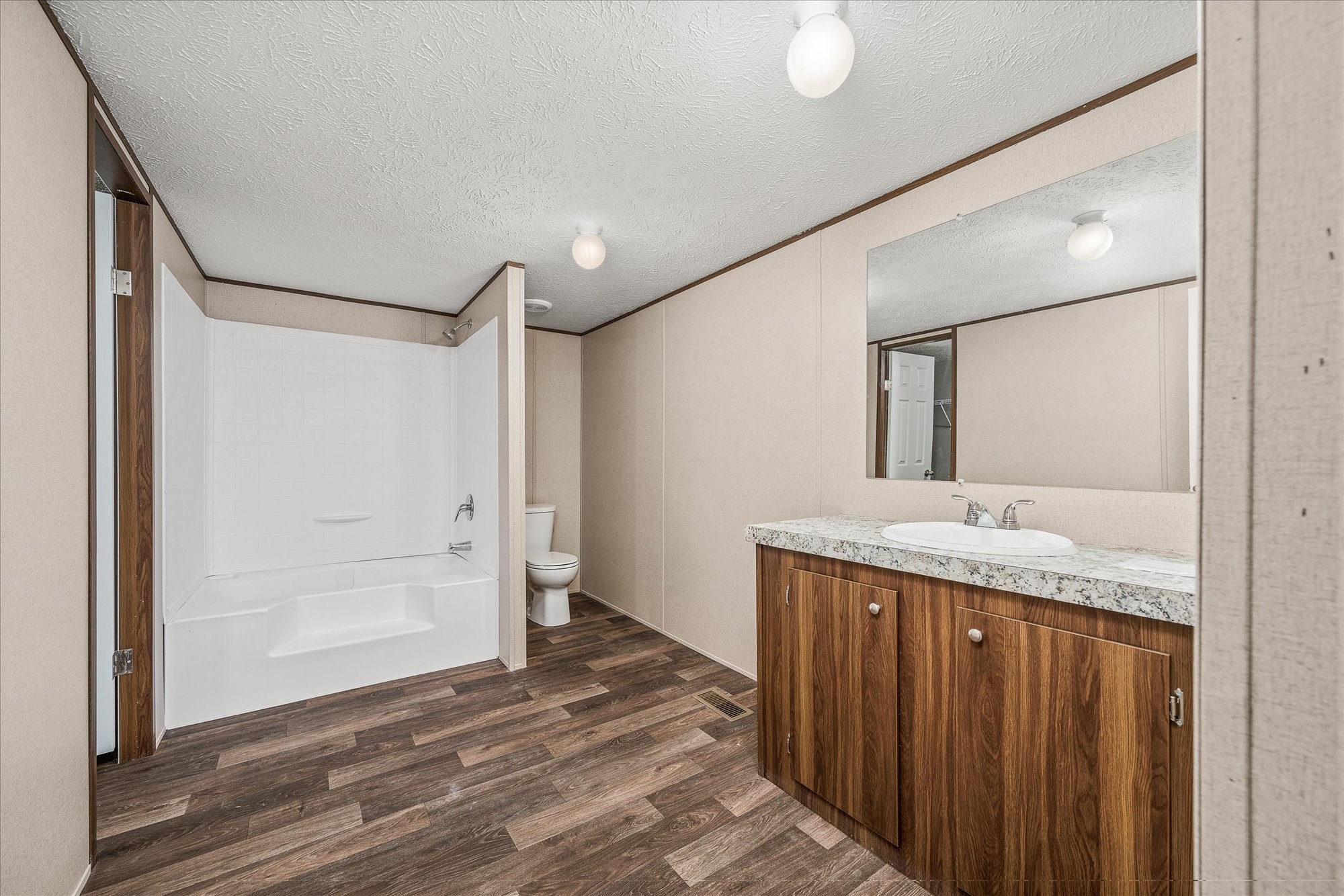 750 Maple Branch Road Sparta, TN 38583 - Photo 18 of 36 a bathroom with a granite countertop sink and a mirror
