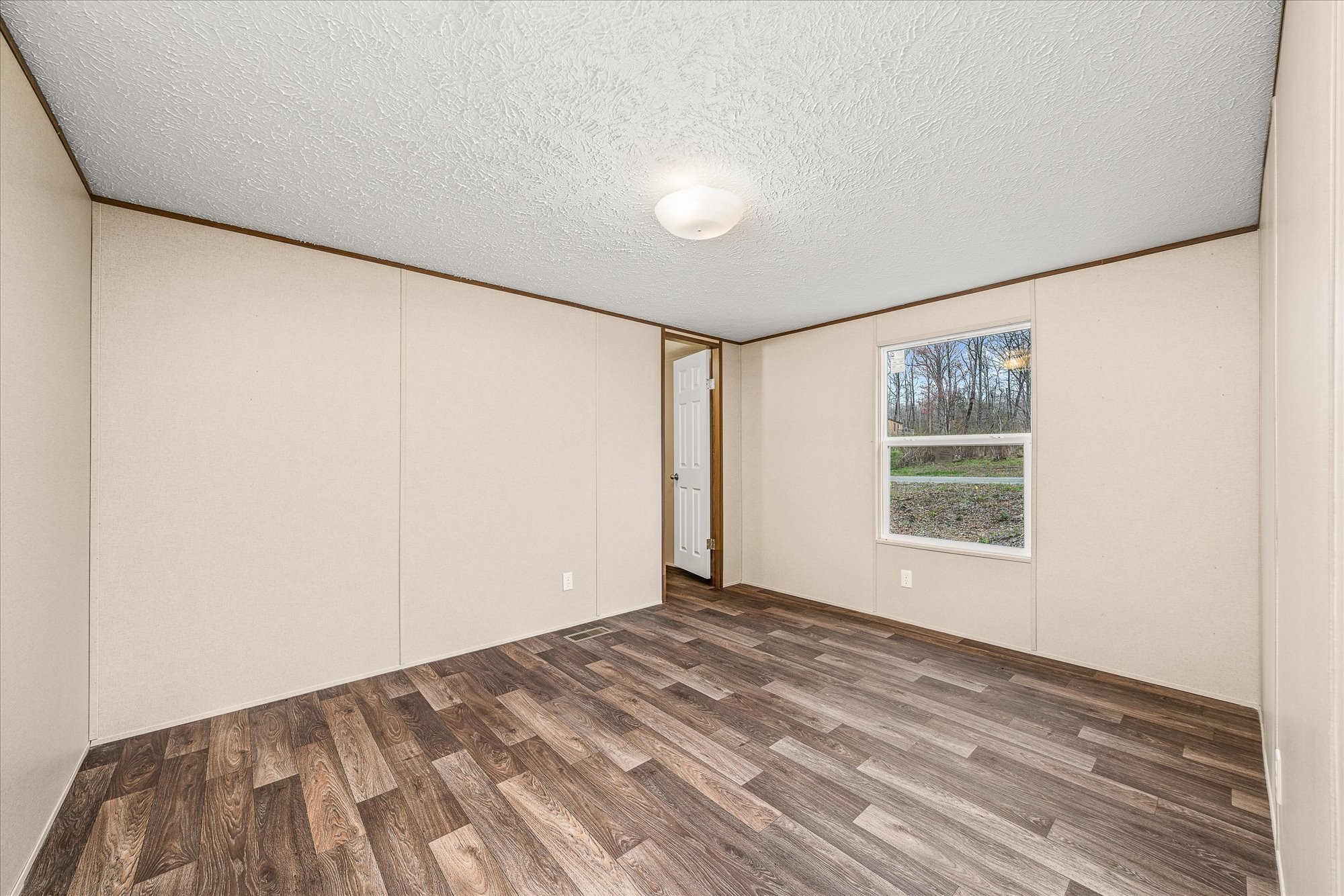 750 Maple Branch Road Sparta, TN 38583 - Photo 20 of 36 a view of a big room with wooden floor and windows in a room