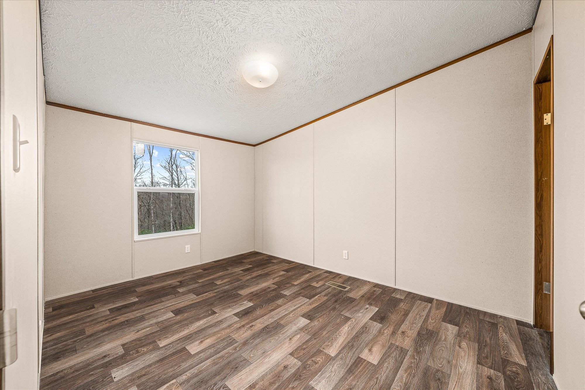 750 Maple Branch Road Sparta, TN 38583 - Photo 22 of 36 a view of empty room with wooden floor and fan
