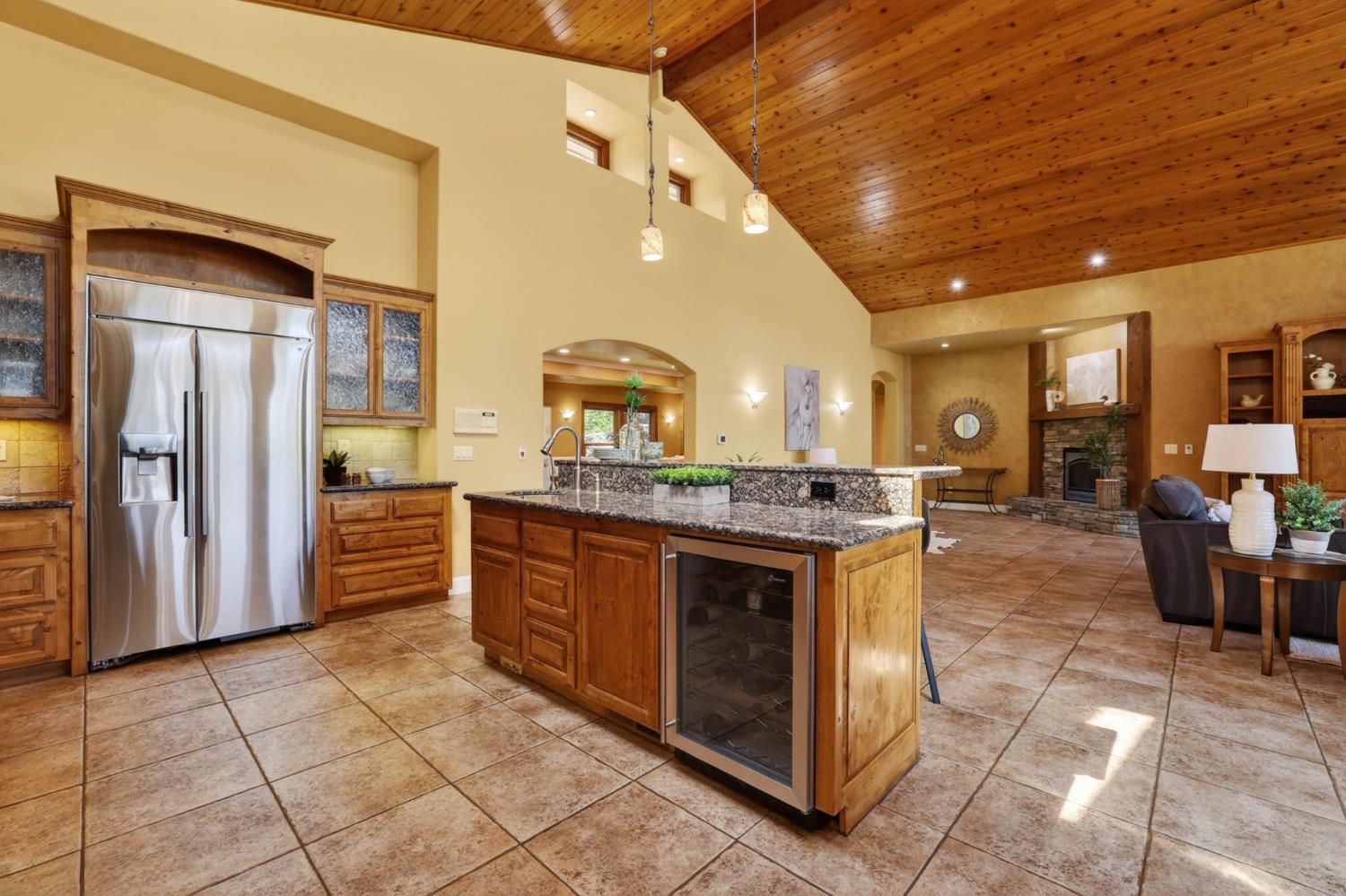 7021 Horseshoe Bar Road Loomis, CA 95650 - Photo 14 of 77 Grand, open-concept kitchen anchored by a generous island and high-end built-in refrigerator, ideally positioned just off the formal dining room for a natural flow when hosting.