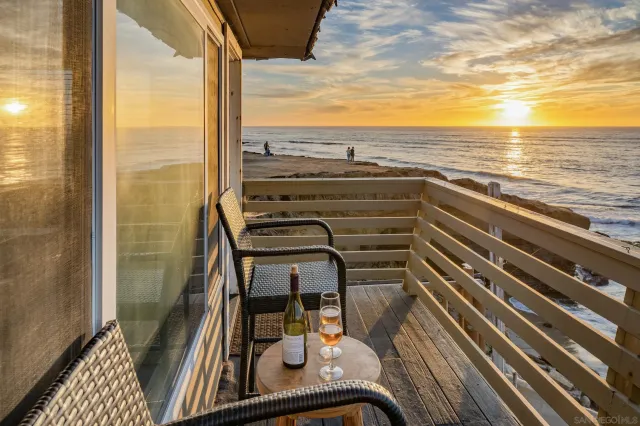 a kitchen with granite countertop kitchen island stainless steel appliances a sink stove and white cabinets