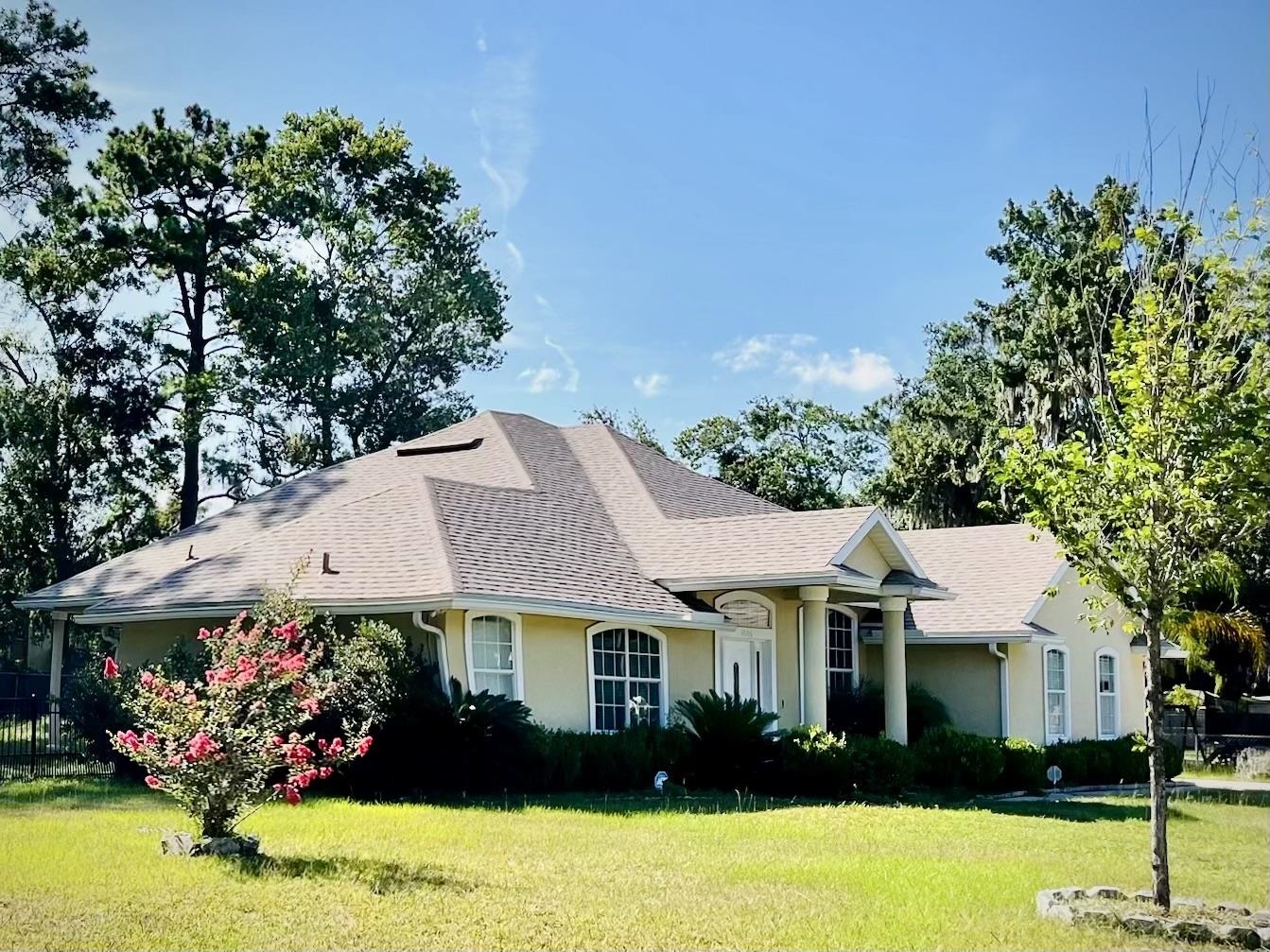 9606 Melvina Road Jacksonville, FL 32257 - Photo 1 of 23 View of front of home with a front lawn, stucco siding, and roof with shingles