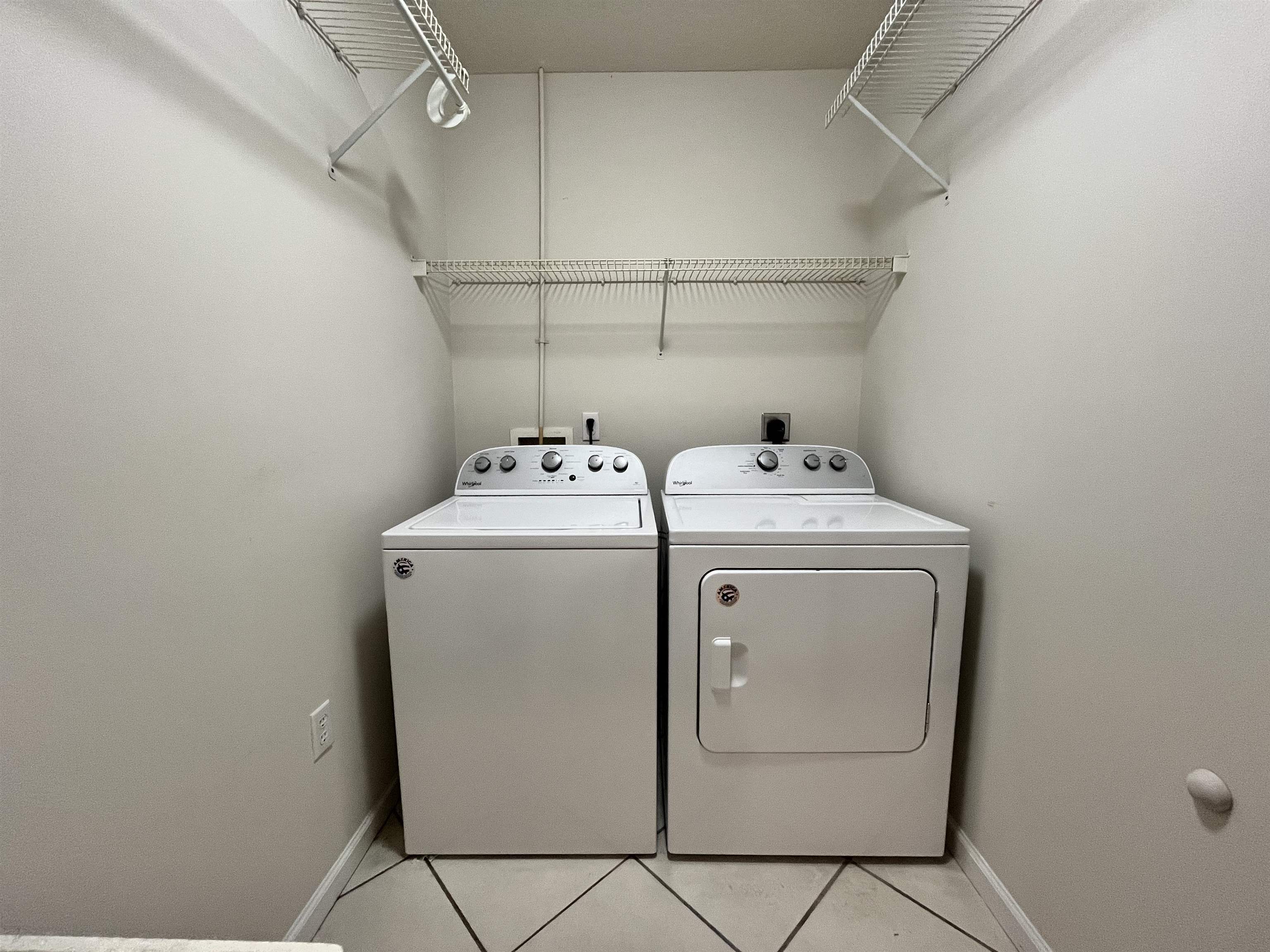 9606 Melvina Road Jacksonville, FL 32257 - Photo 17 of 23 Laundry area featuring light tile patterned floors and washer and dryer