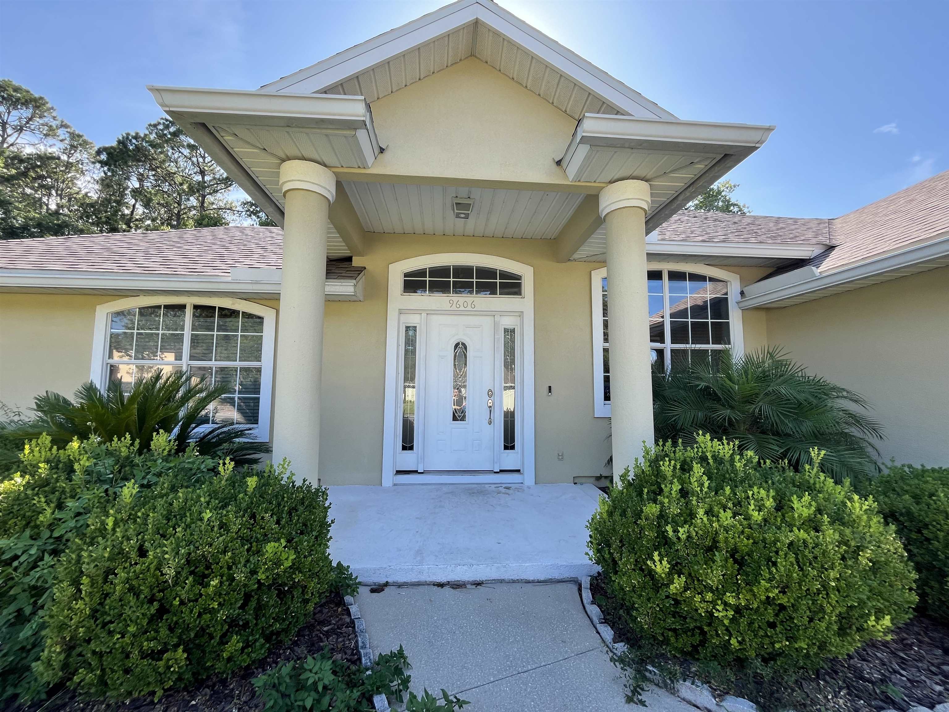9606 Melvina Road Jacksonville, FL 32257 - Photo 3 of 23 Doorway to property featuring stucco siding and roof with shingles