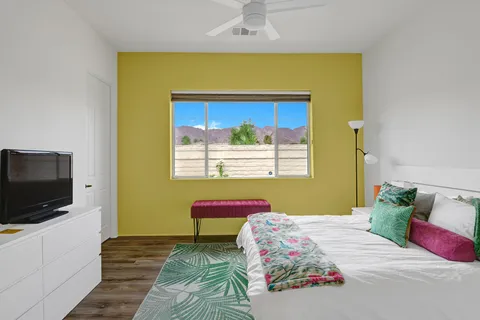 a bedroom with a bed and a flat screen tv