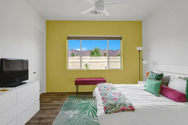 a bedroom with a bed and a flat screen tv