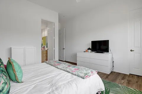 a bedroom with a bed and a television