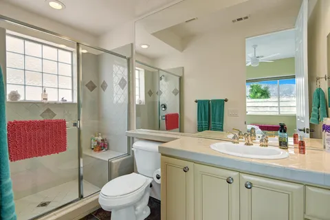 a bathroom with a sink toilet vanity and shower