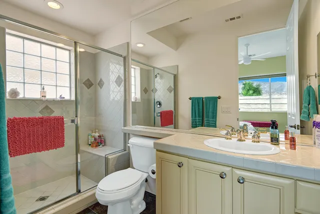 a bathroom with a sink toilet vanity and shower