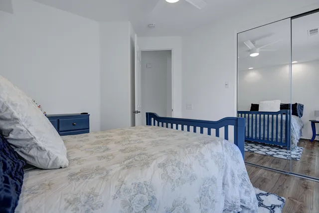 a bed sitting in a bedroom and wooden floor