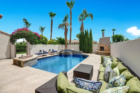 a view of swimming pool with outdoor seating and plants