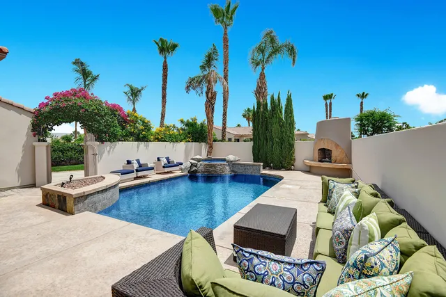a view of swimming pool with outdoor seating and plants