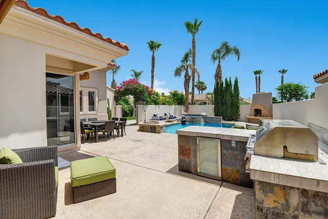 a view of outdoor kitchen and dining table