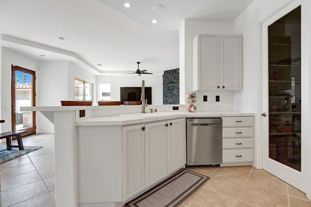 a kitchen with cabinets appliances and a counter space