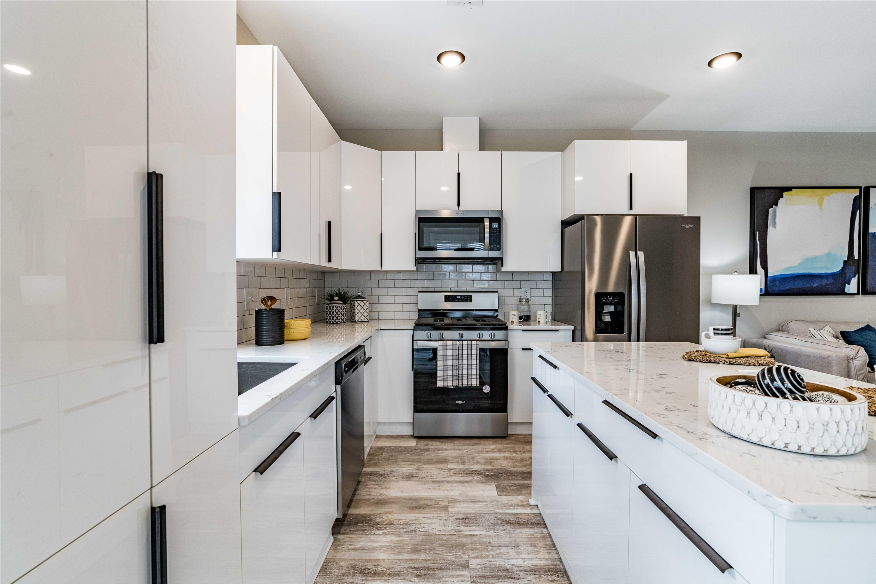 1035 Nano Tech Circle Durham, NC 27704 - Photo 14 of 38 a kitchen with white cabinets and stainless steel appliances