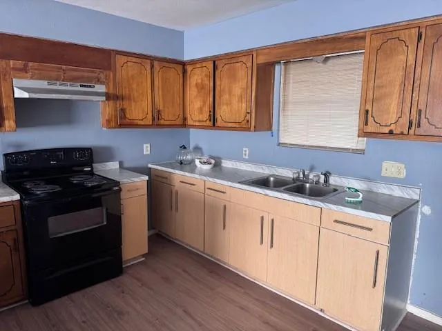 a kitchen with a sink stove and cabinets