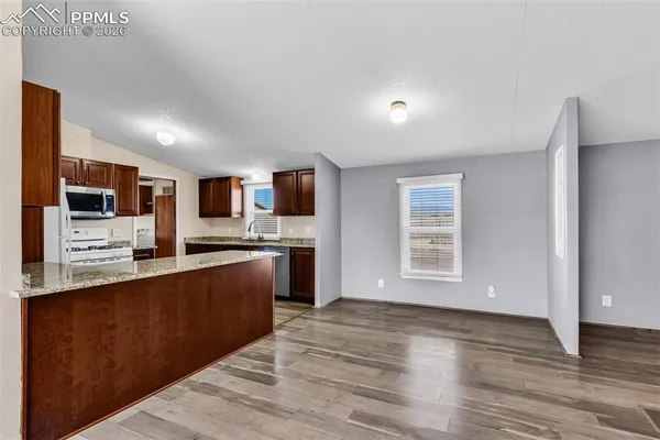 a view of a kitchen with microwave and cabinets