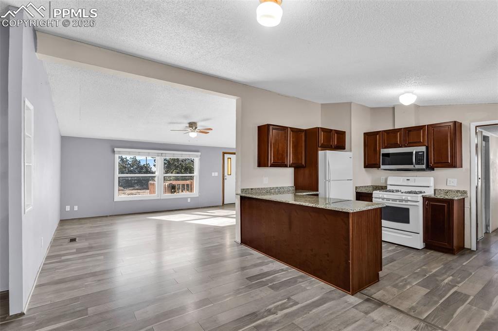 1044 P Street Penrose, CO 81240 - Photo 12 of 48 a view of a kitchen with microwave and cabinets