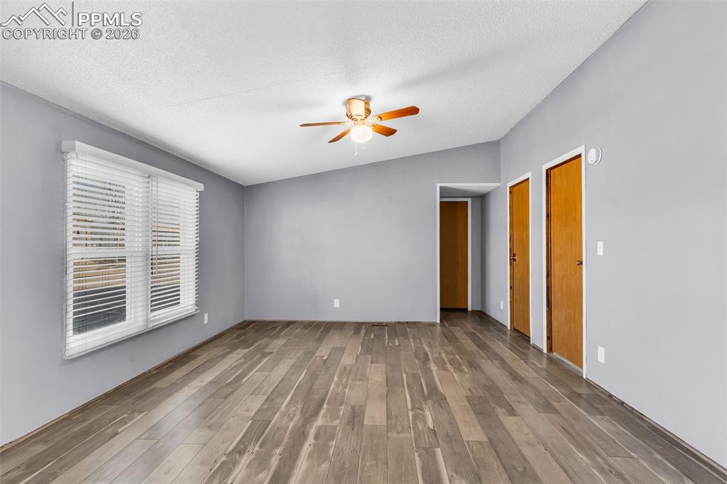 1044 P Street Penrose, CO 81240 - Photo 18 of 48 a view of an empty room with a window and wooden floor