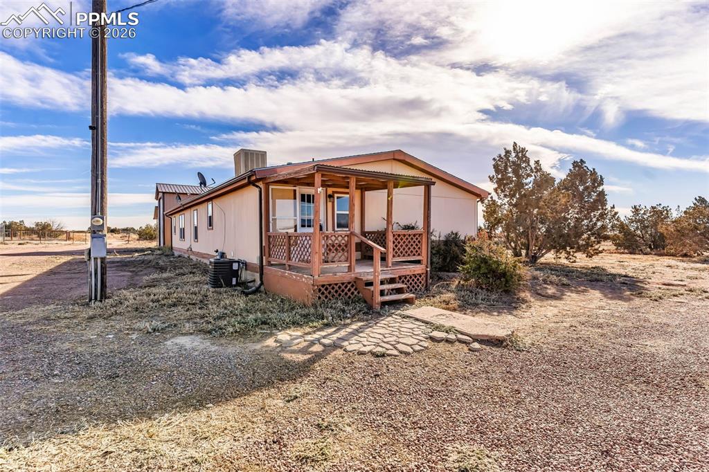 1044 P Street Penrose, CO 81240 - Photo 34 of 48 a view of a house with a yard and wooden fence