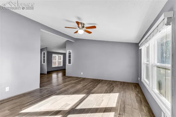 a view of livingroom with hardwood floor and ceiling fan