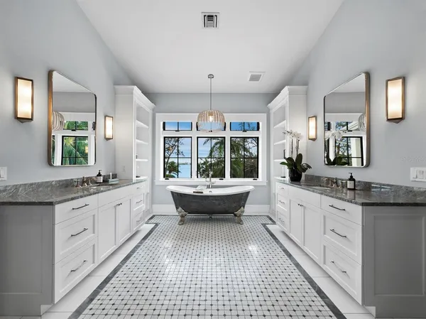 a spacious bedroom with a large bed and a flat screen tv