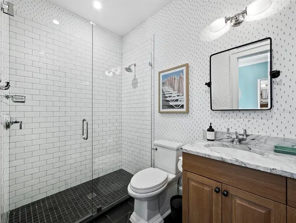 a bathroom with a granite countertop sink and a large mirror