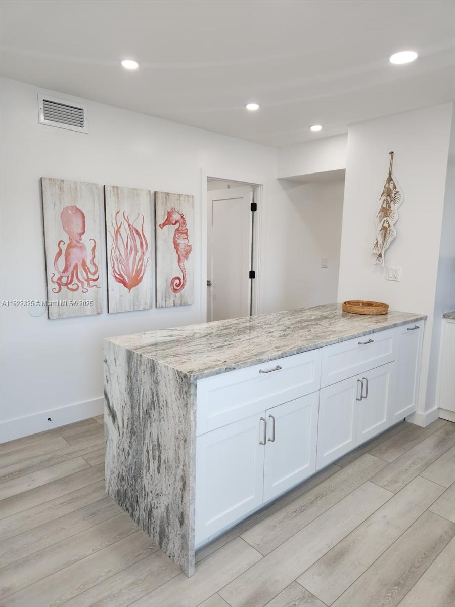 3320 Gulf Of Mexico Drive, Unit 208C Longboat Key, FL 34228 - Photo 11 of 39 a bathroom with double vanity sink and a mirror