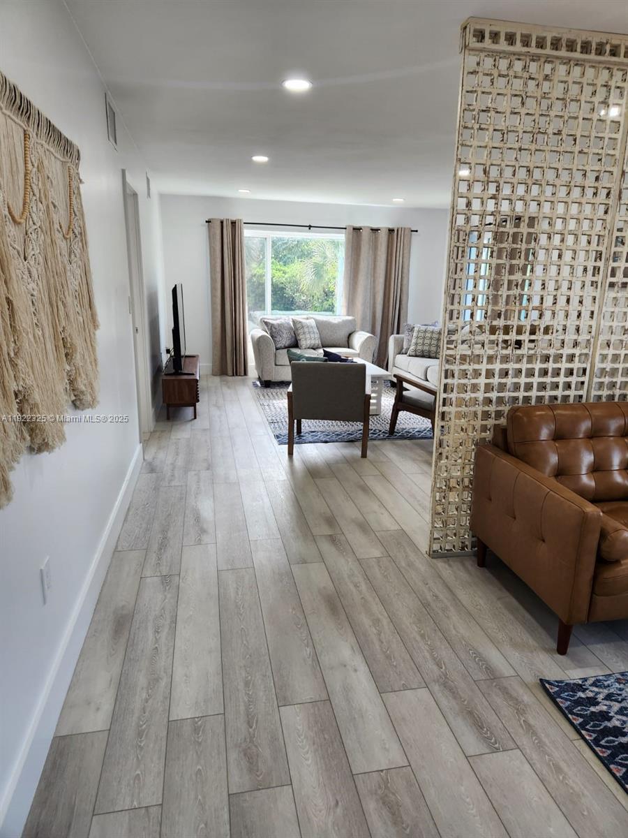 3320 Gulf Of Mexico Drive, Unit 208C Longboat Key, FL 34228 - Photo 12 of 39 a living room with furniture and a rug