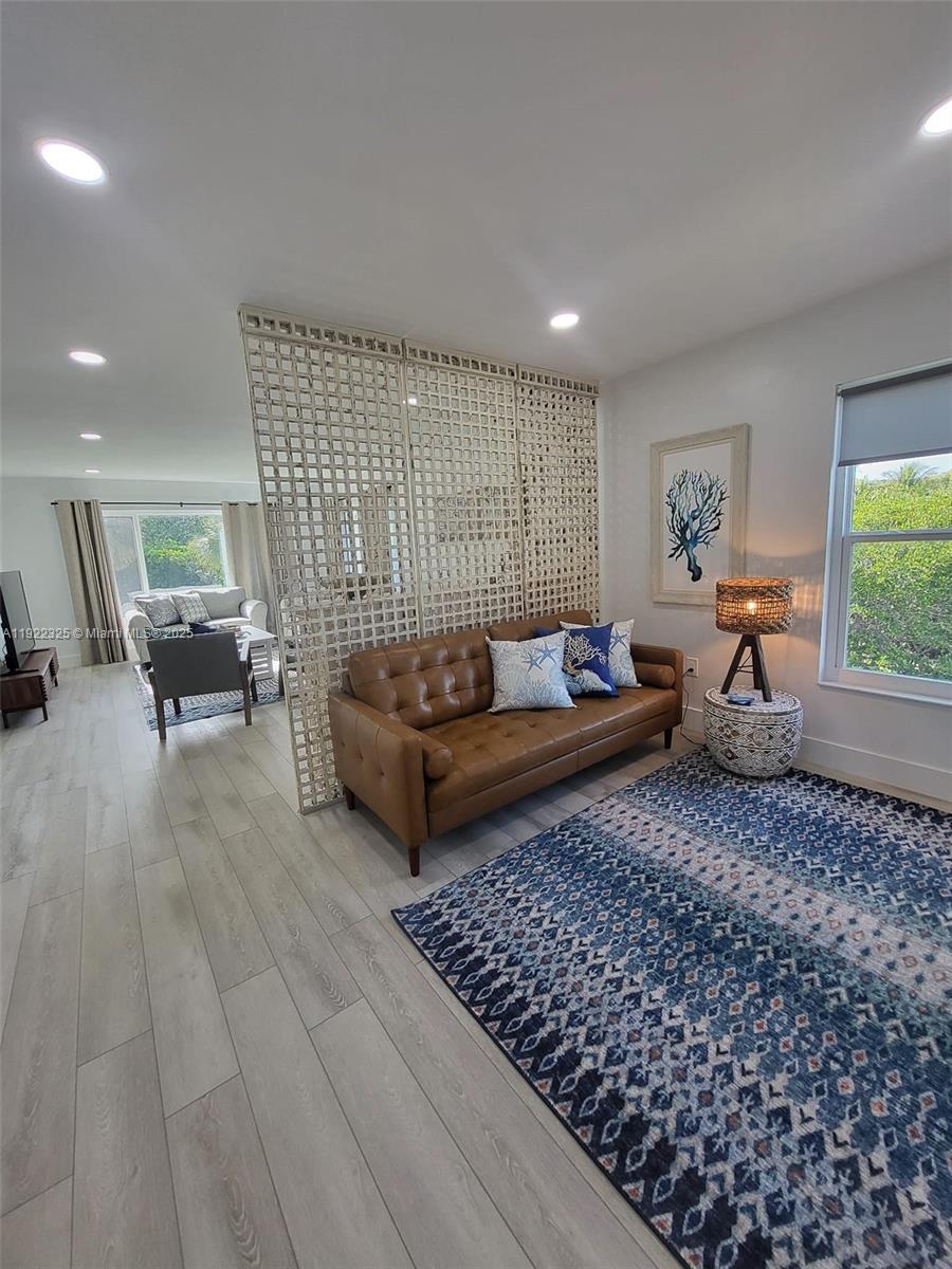 3320 Gulf Of Mexico Drive, Unit 208C Longboat Key, FL 34228 - Photo 14 of 39 a living room with furniture rug and window