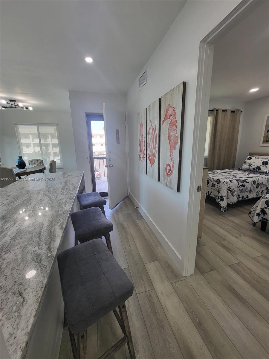 3320 Gulf Of Mexico Drive, Unit 208C Longboat Key, FL 34228 - Photo 15 of 39 a living room with furniture and wooden floor