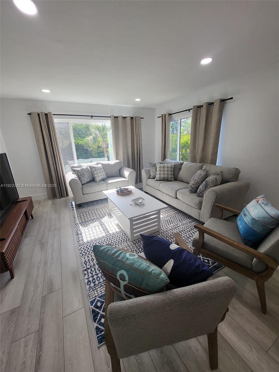 3320 Gulf Of Mexico Drive, Unit 208C Longboat Key, FL 34228 - Photo 18 of 39 a living room with furniture and a couch