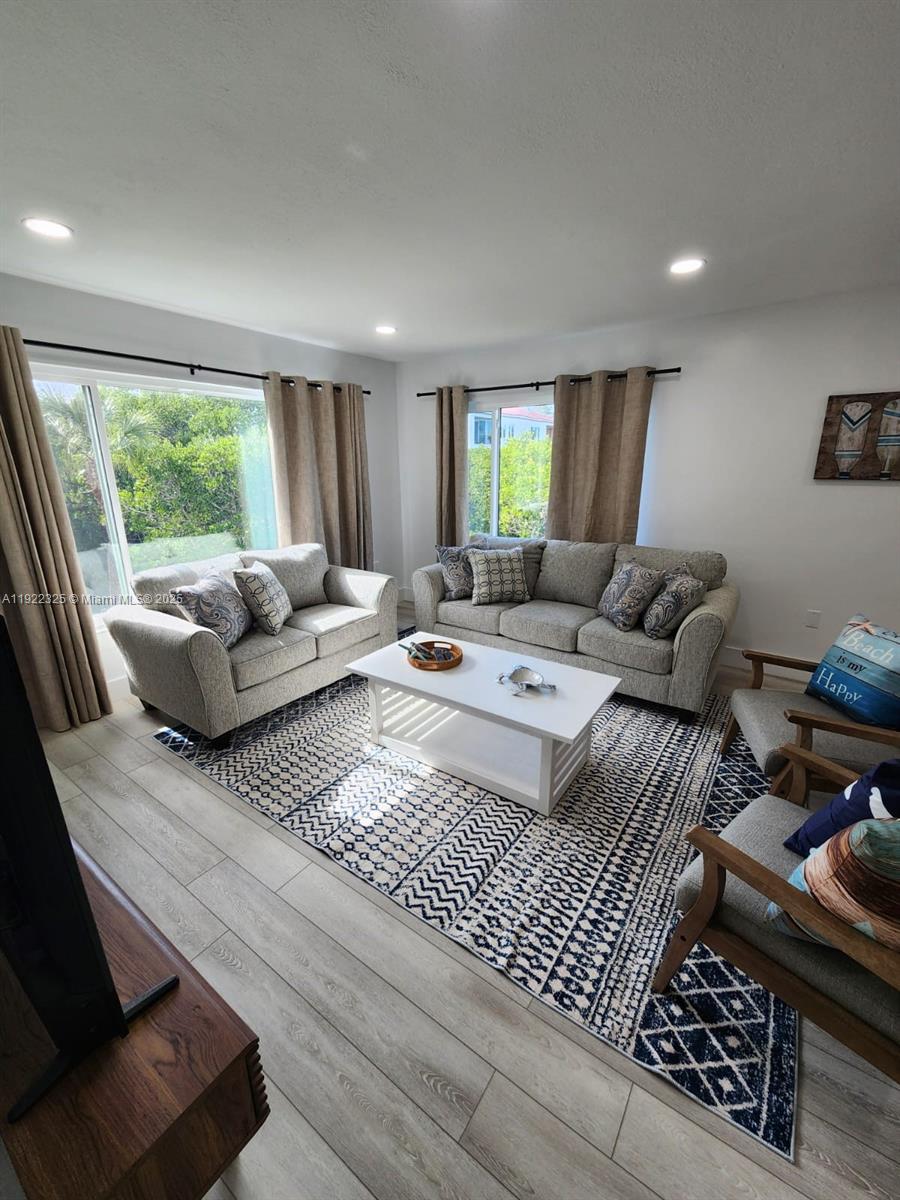 3320 Gulf Of Mexico Drive, Unit 208C Longboat Key, FL 34228 - Photo 23 of 39 a living room with furniture and a large window