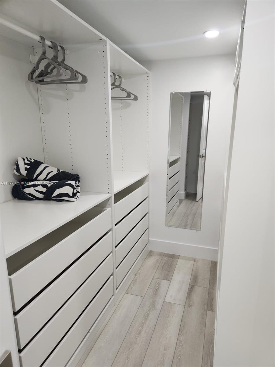 3320 Gulf Of Mexico Drive, Unit 208C Longboat Key, FL 34228 - Photo 30 of 39 a bathroom with a sink and a mirror