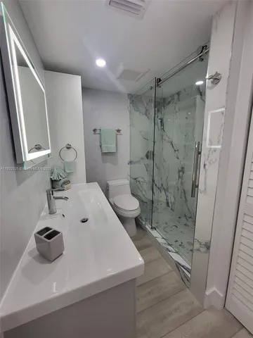 a bathroom with a sink toilet and shower