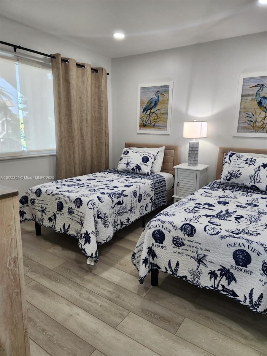 3320 Gulf Of Mexico Drive, Unit 208C Longboat Key, FL 34228 - Photo 35 of 39 a bedroom with two beds and a window