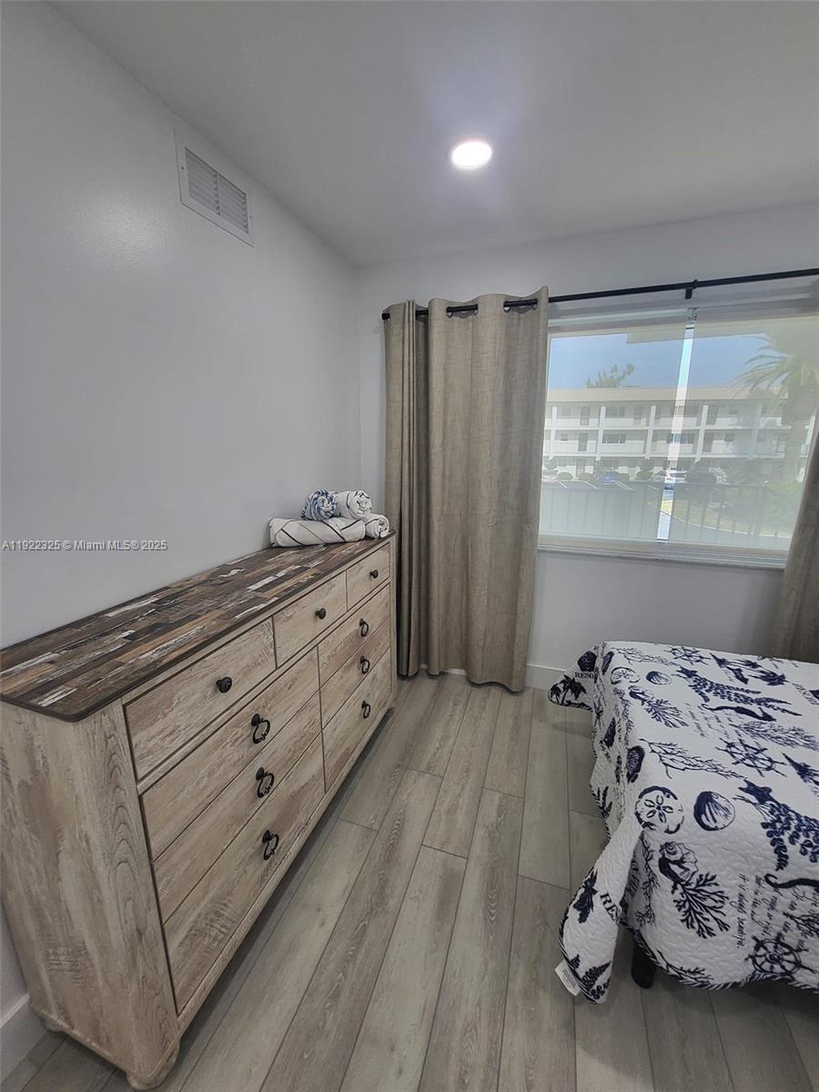 3320 Gulf Of Mexico Drive, Unit 208C Longboat Key, FL 34228 - Photo 36 of 39 a bedroom with a bed and a window