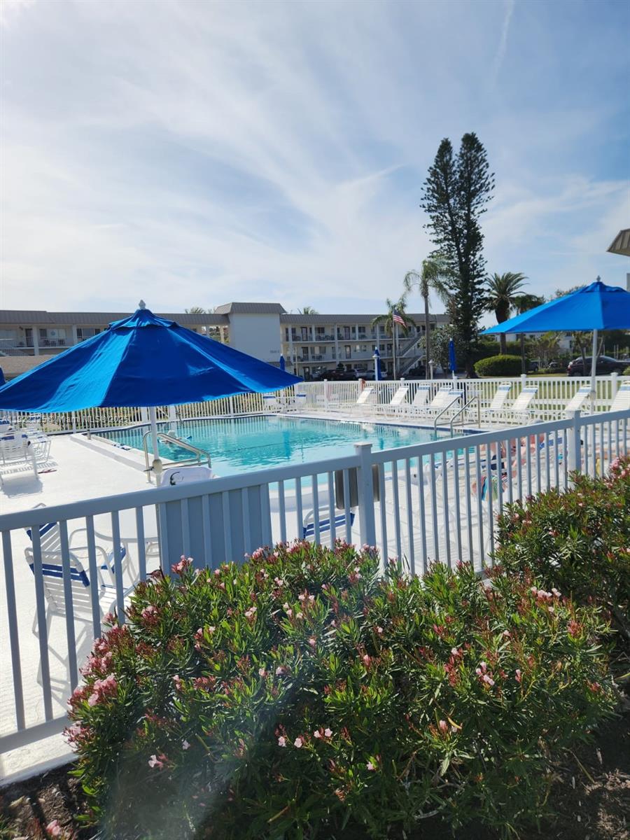 3320 Gulf Of Mexico Drive, Unit 208C Longboat Key, FL 34228 - Photo 37 of 39 a view of a house with a yard and porch